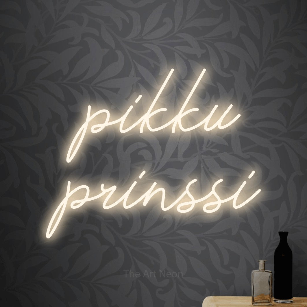 LED neon sign reading “pikku prinssi”, arranged in 2 lines.