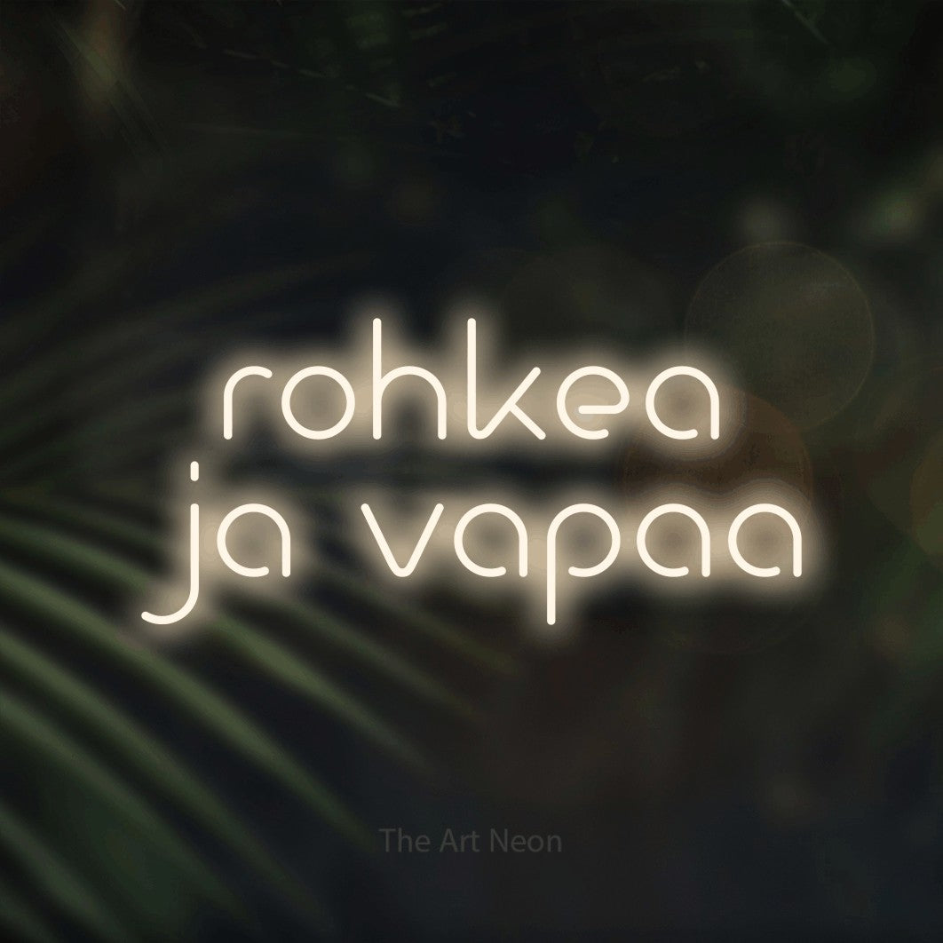 LED neon sign reading “rohkea ja vapaa”, arranged in 2 lines.