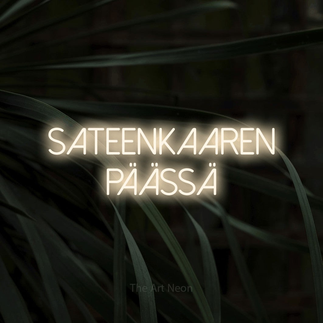 LED neon sign reading “Sateenkaaren päässä”, arranged in 2 lines.