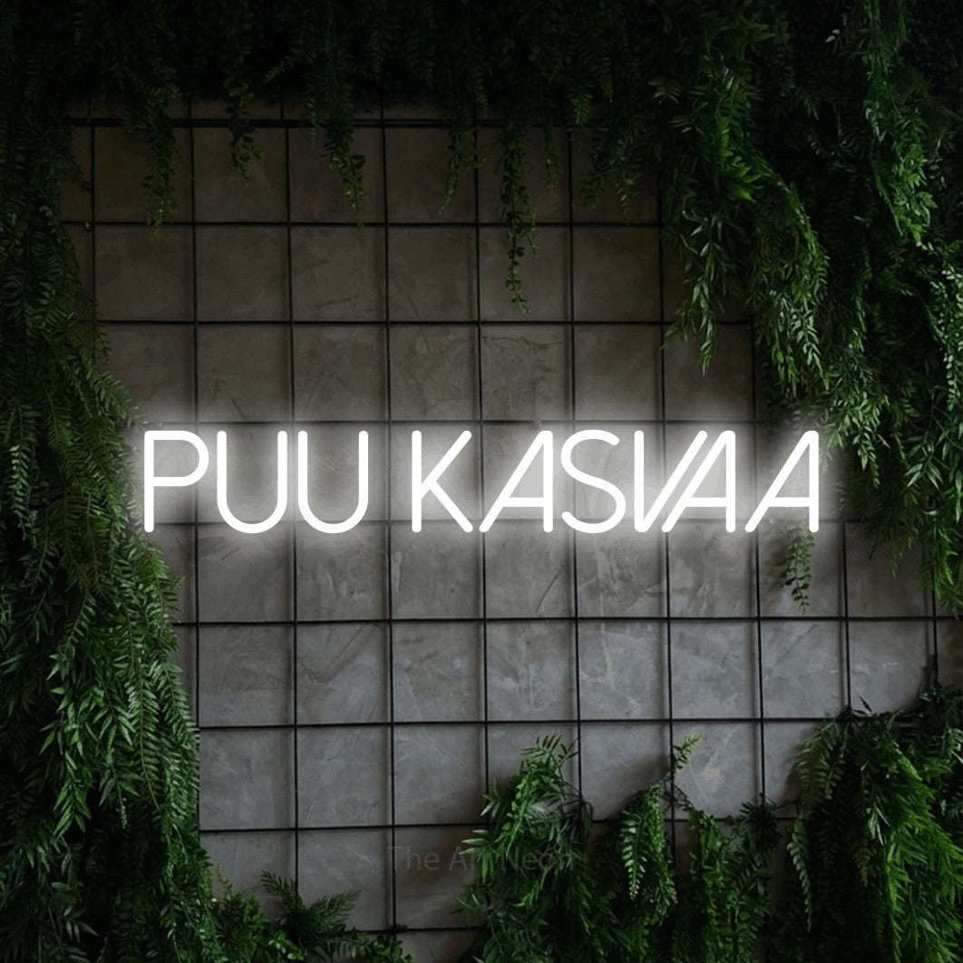 LED neon sign reading “Puu kasvaa”, arranged in a single line.