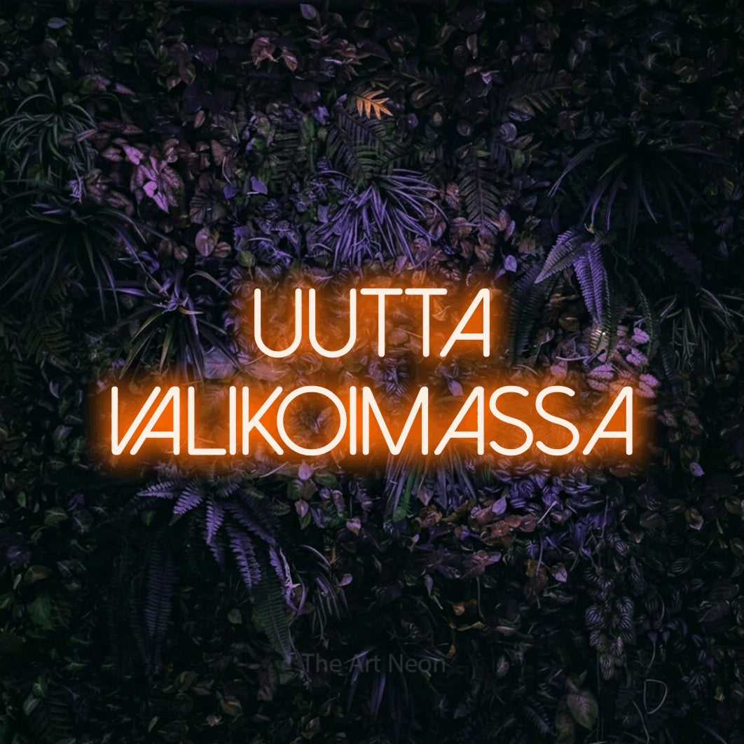 LED neon sign reading “UUTTA VALIKOIMASSA”, arranged in 2 lines.