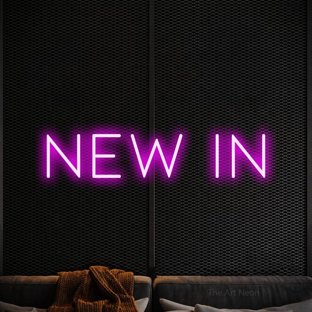 LED neon sign reading “New in”, arranged in a single line.