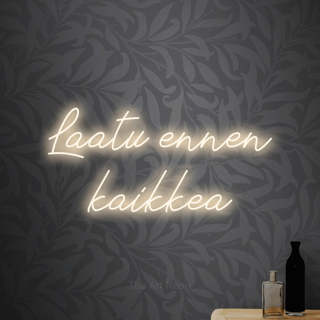 LED neon sign reading “Laatu ennen kaikkea”, arranged in 2 lines.