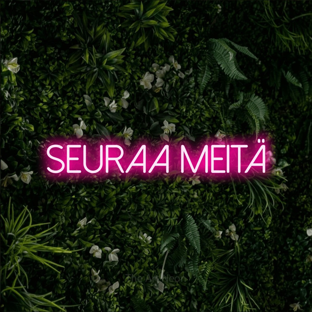 LED neon sign reading “Seuraa meitä”, arranged in a single line.