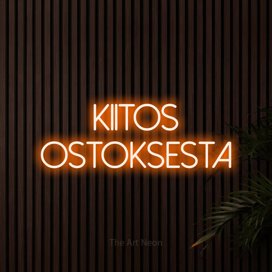 LED neon sign reading “kiitos ostoksesta”, arranged in 2 lines.