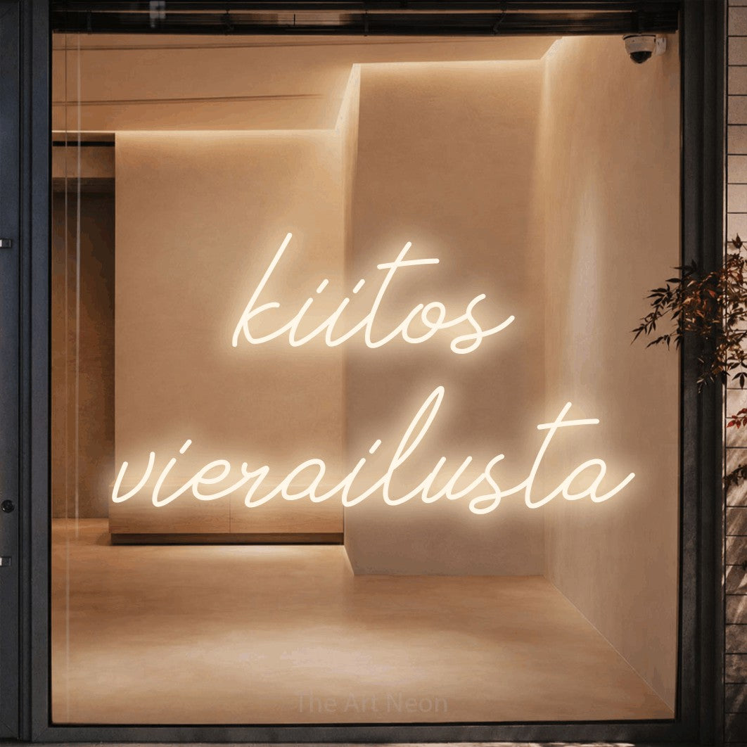 LED neon sign reading “kiitos vierailusta”, arranged in 2 lines.