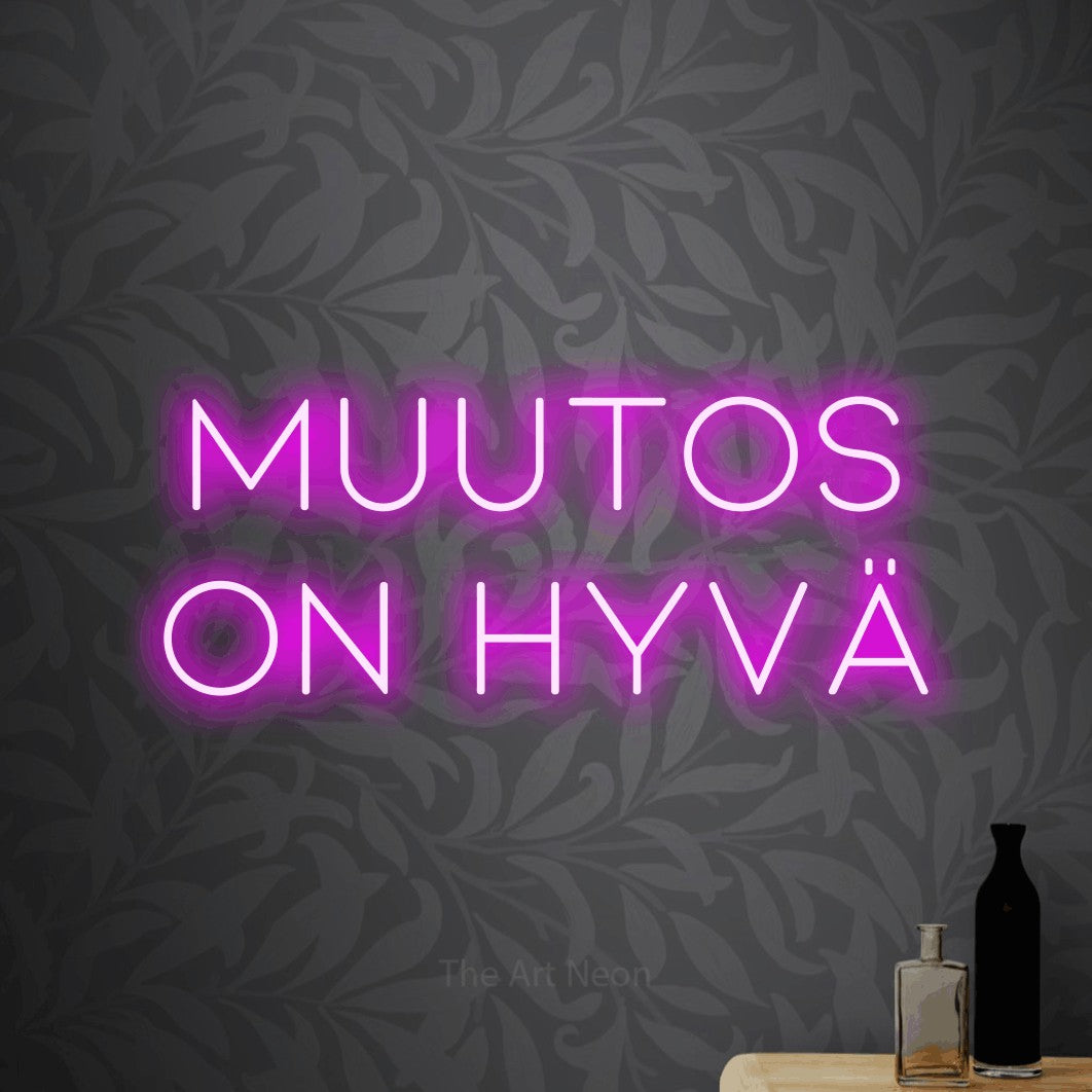 LED neon sign reading “Muutos on hyvä”, arranged in 2 lines.