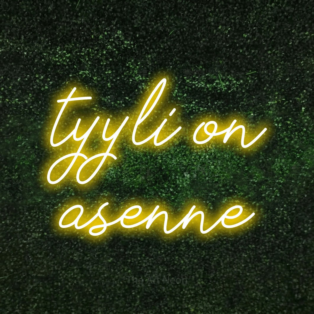 LED neon sign reading “tyyli on asenne”, arranged in 2 lines.