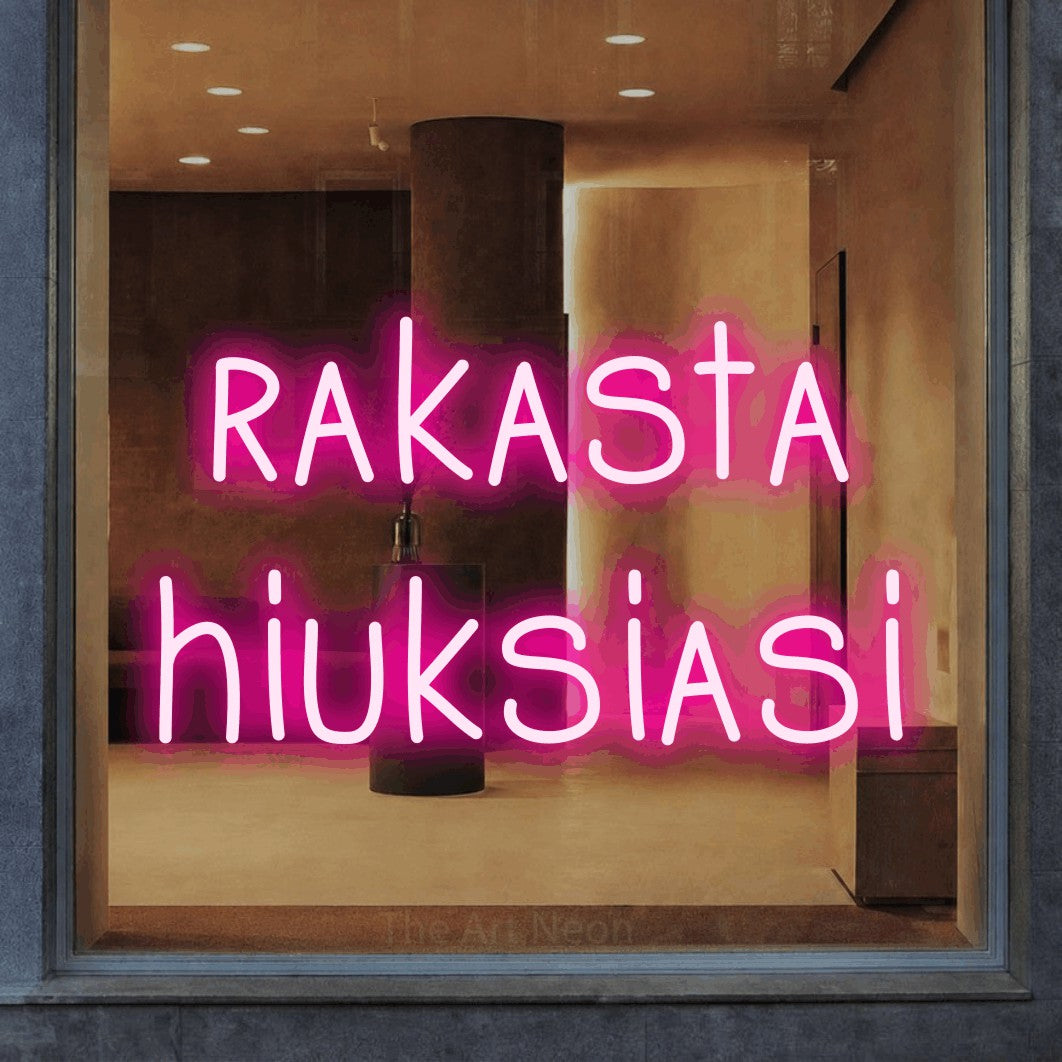 LED neon sign reading “rakasta hiuksiasi”, arranged in 2 lines.