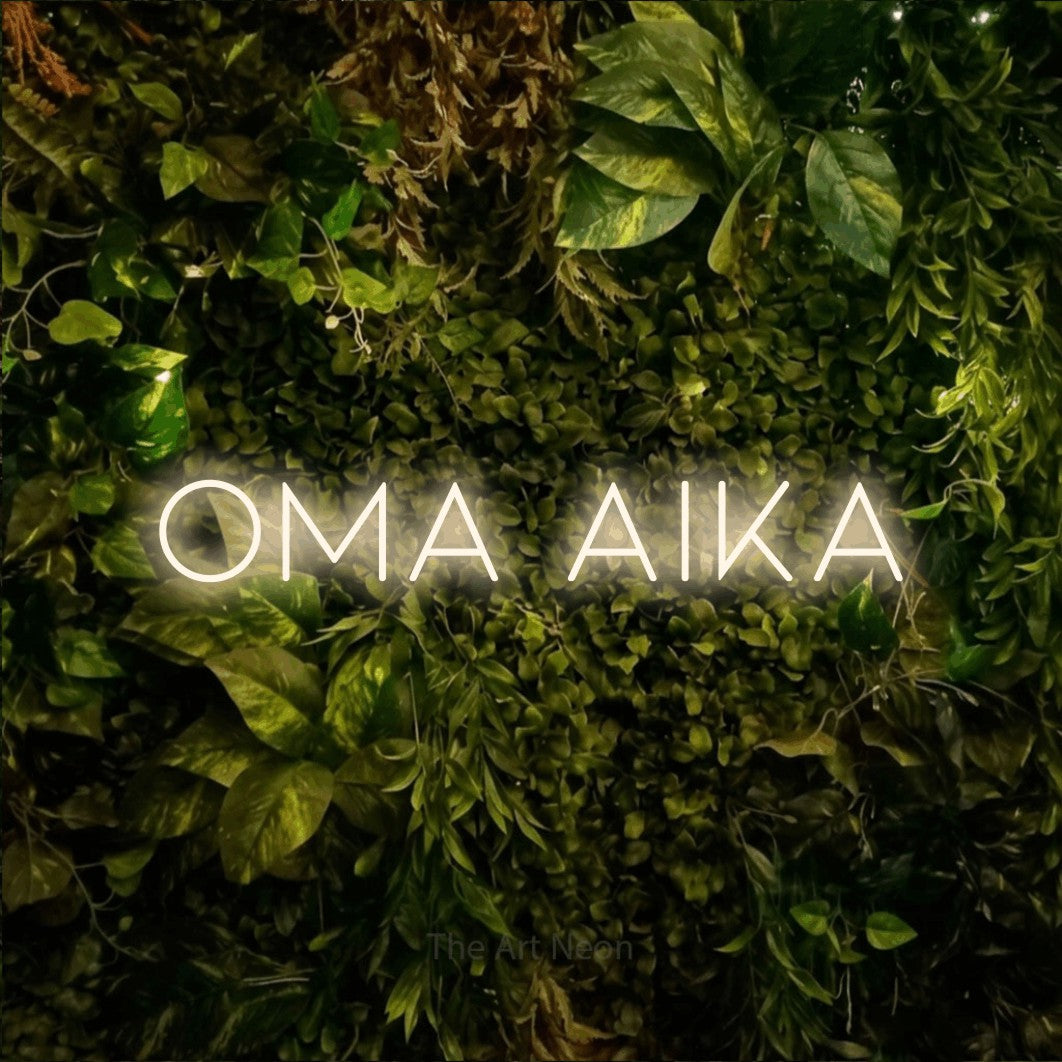 LED neon sign reading “Oma aika”, arranged in a single line.