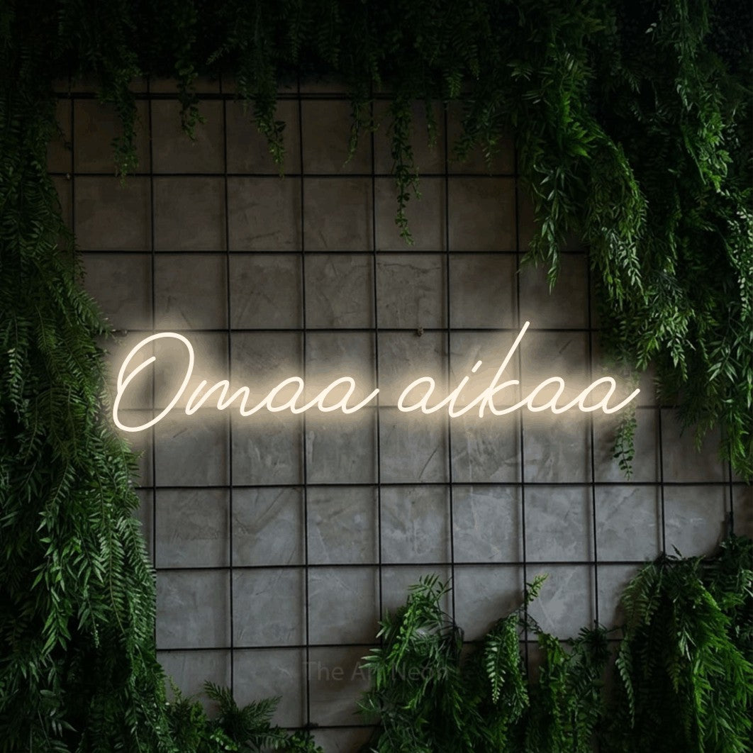 LED neon sign reading “Omaa aikaa”, arranged in a single line.