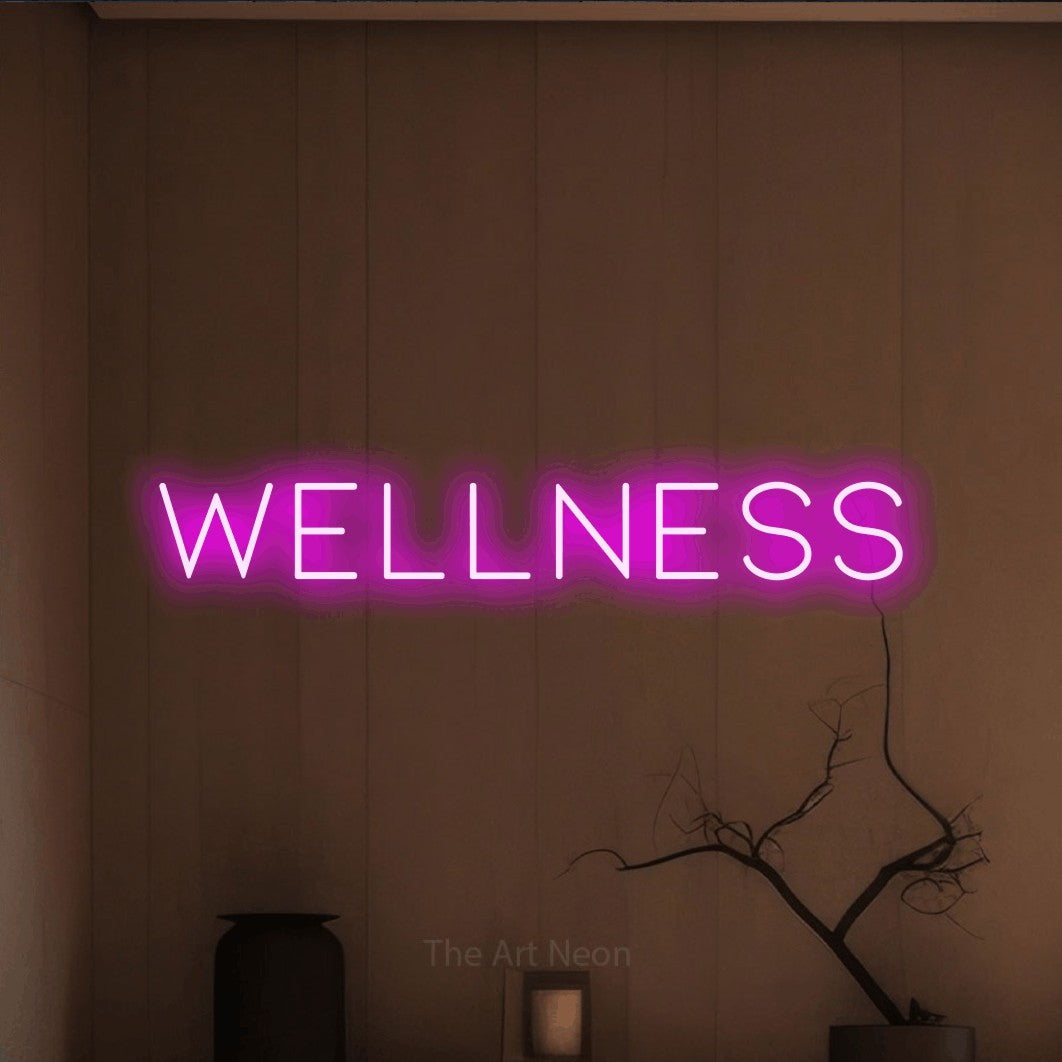 LED neon sign reading “wellness”, arranged in a single line.