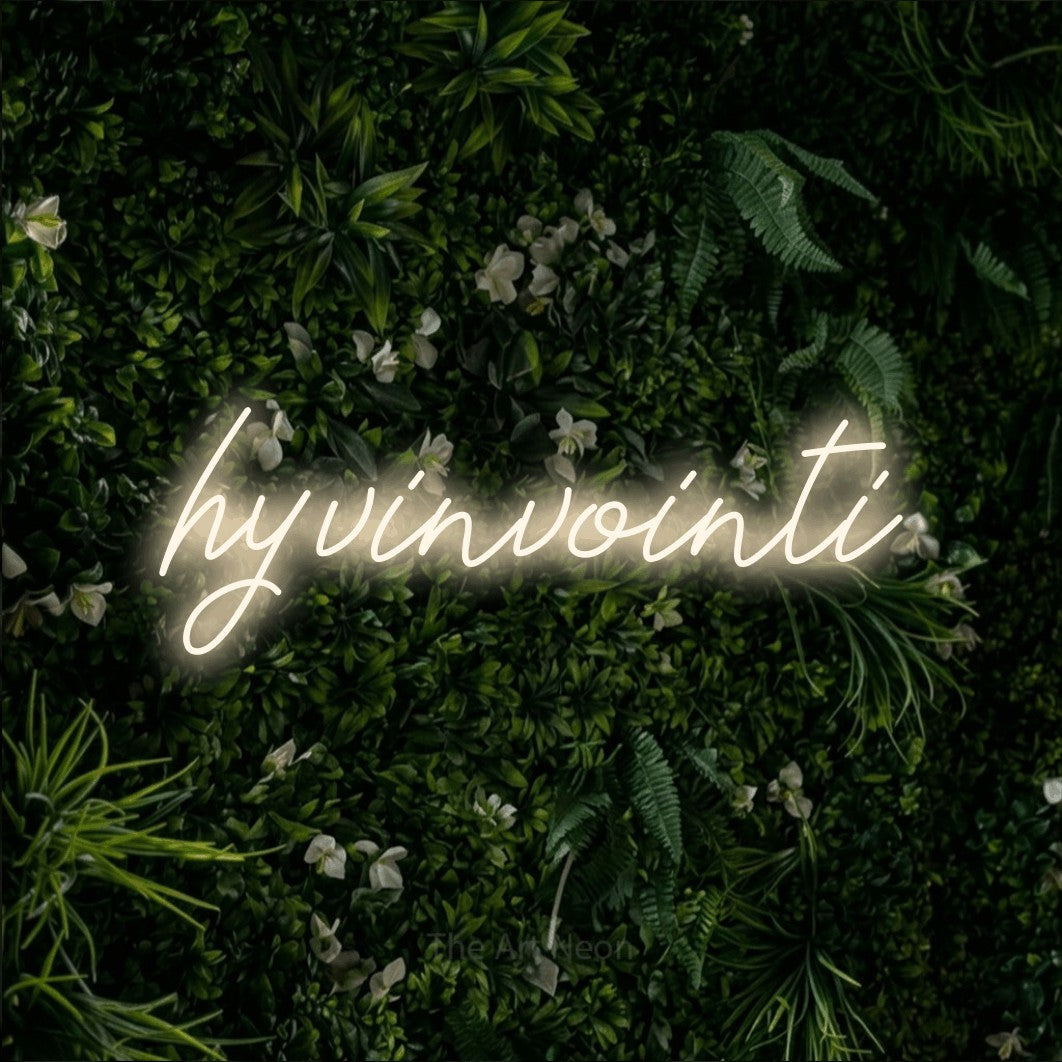 LED neon sign reading “hyvinvointi”, arranged in a single line.
