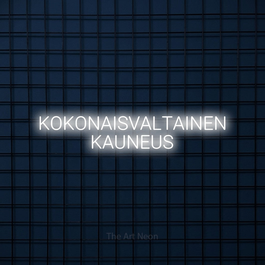 LED neon sign reading “KOKONAISVALTAINEN KAUNEUS”, arranged in 2 lines.