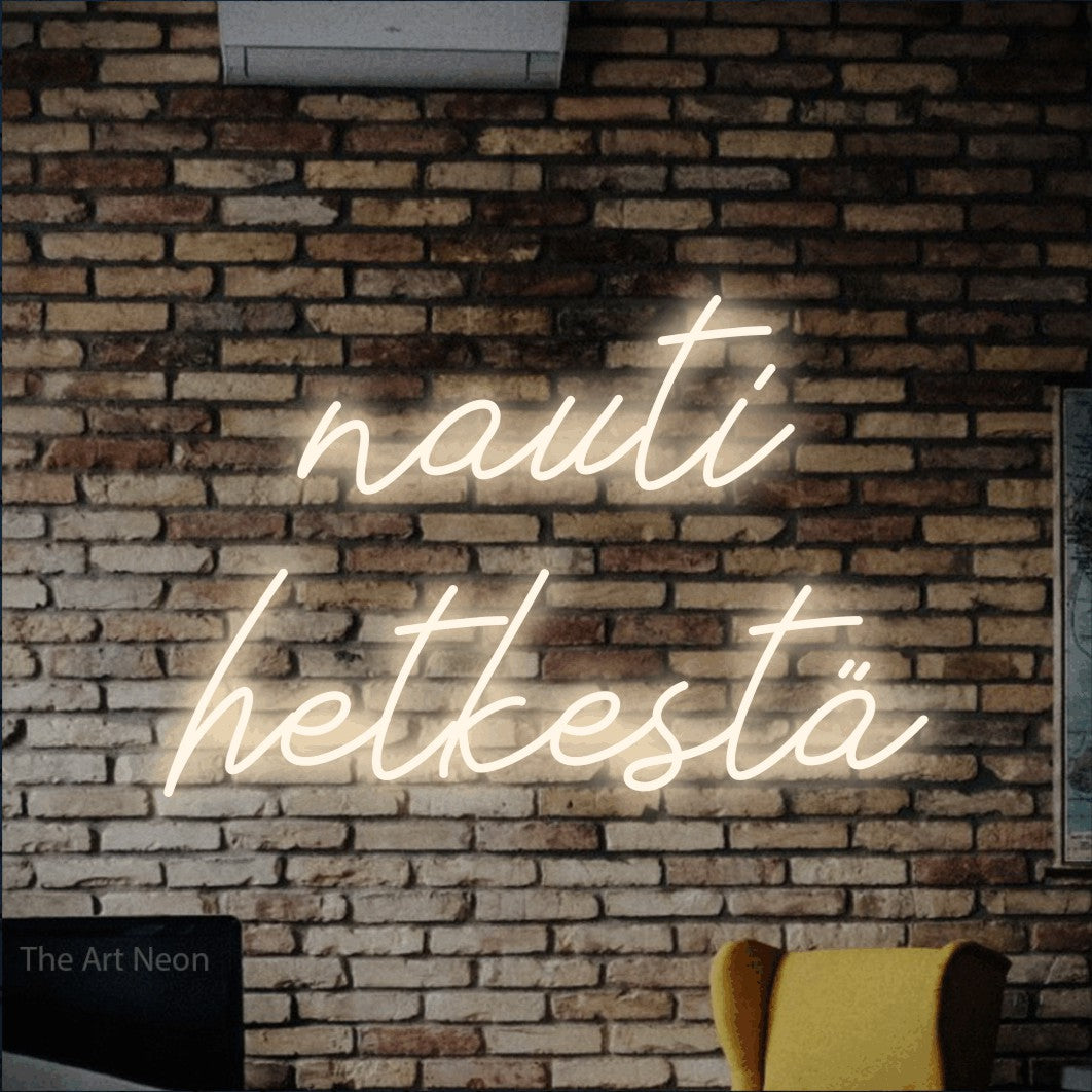 LED neon sign reading “nauti hetkestä”, arranged in 2 lines.
