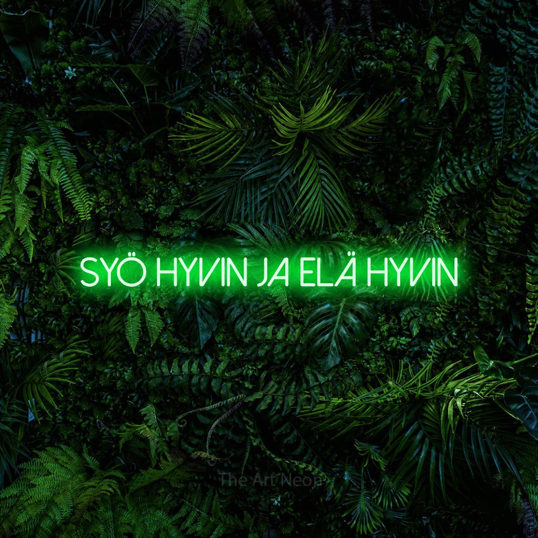 LED neon sign reading “syö hyvin ja elä hyvin”, arranged in a single line.