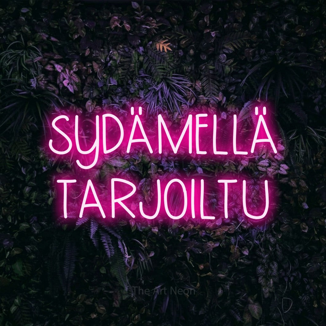 LED neon sign reading “SYDÄMELLÄ TARJOILTU”, arranged in 2 lines.
