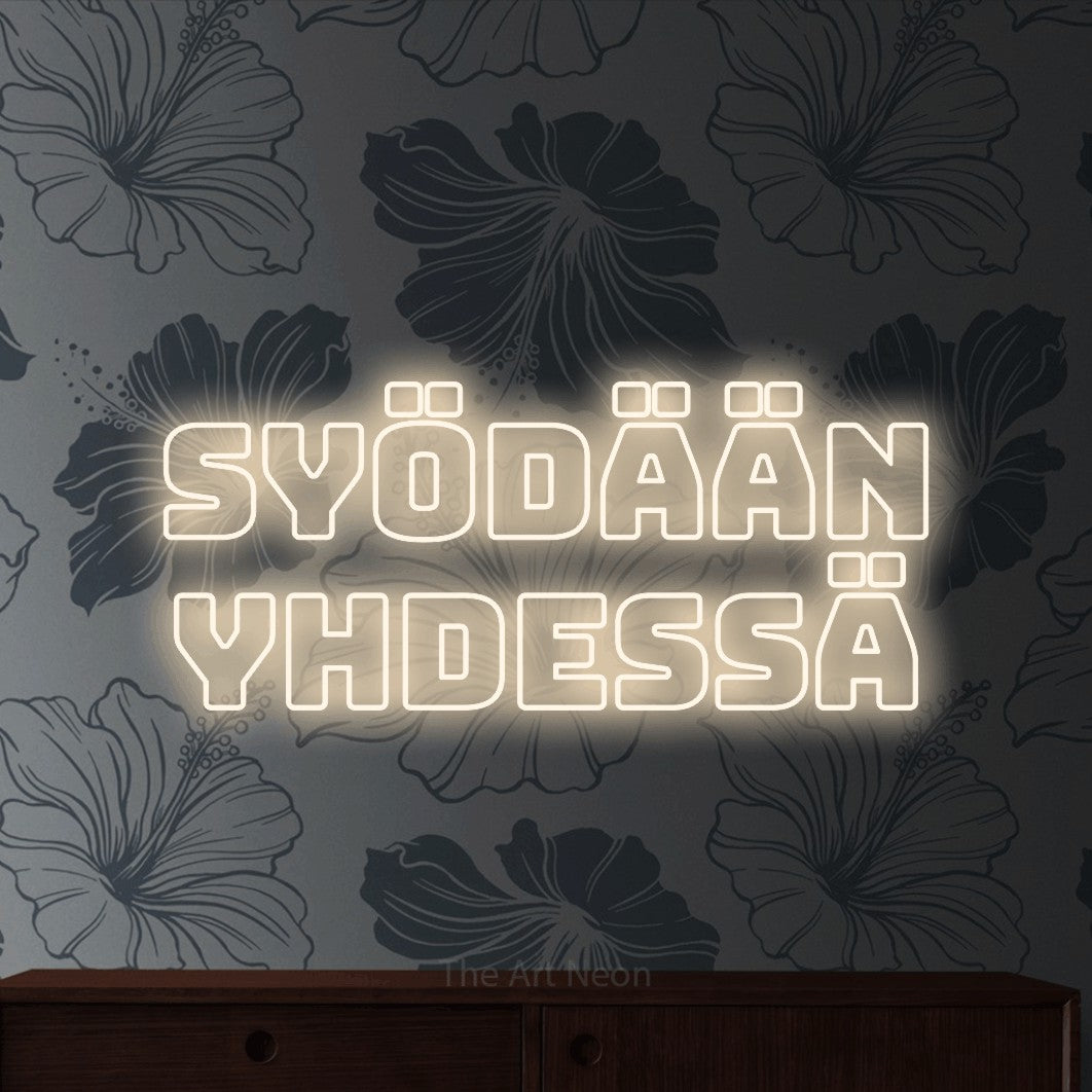 LED neon sign reading “SYÖDÄÄN YHDESSÄ”, arranged in 2 lines.