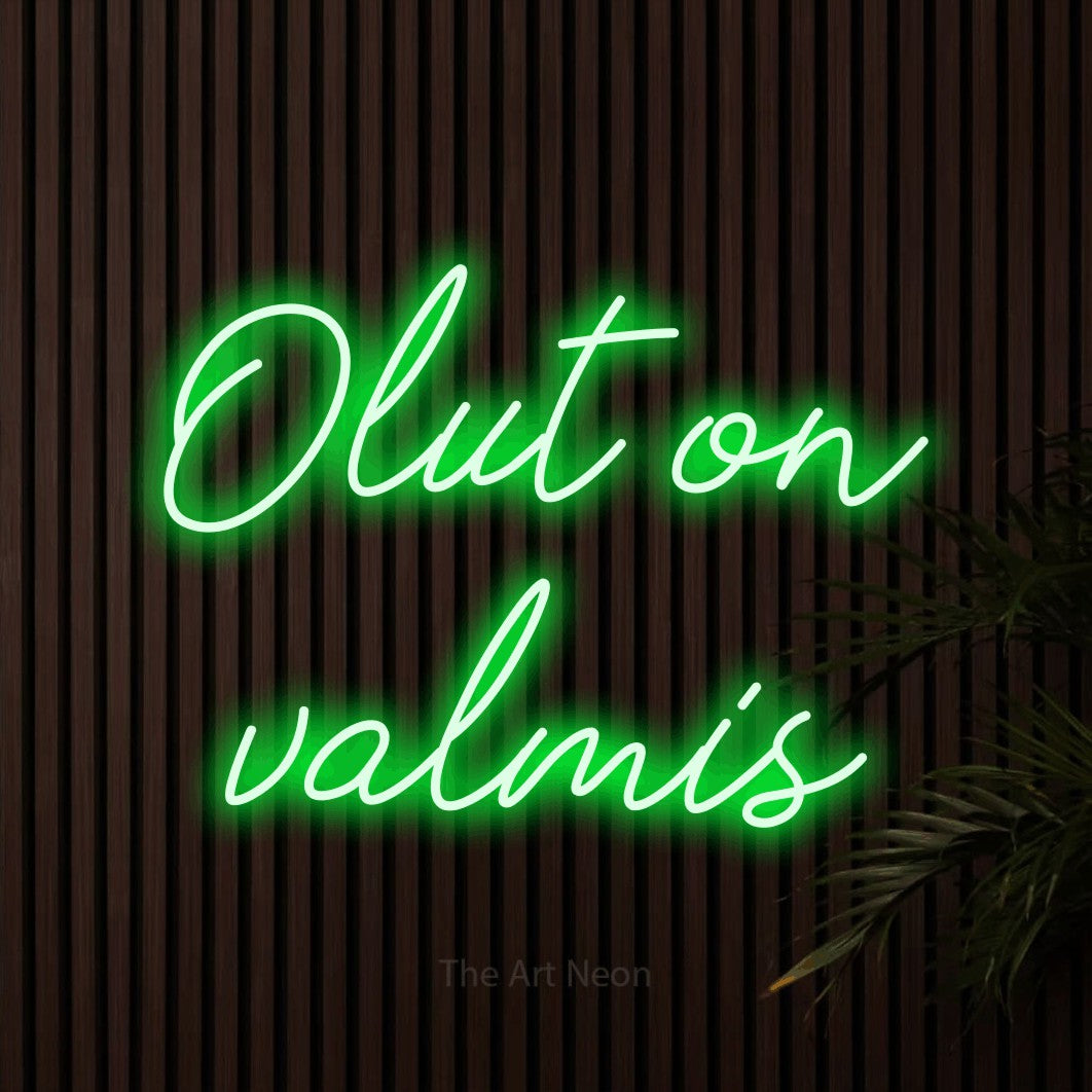 LED neon sign reading “Olut on valmis”, arranged in 2 lines.