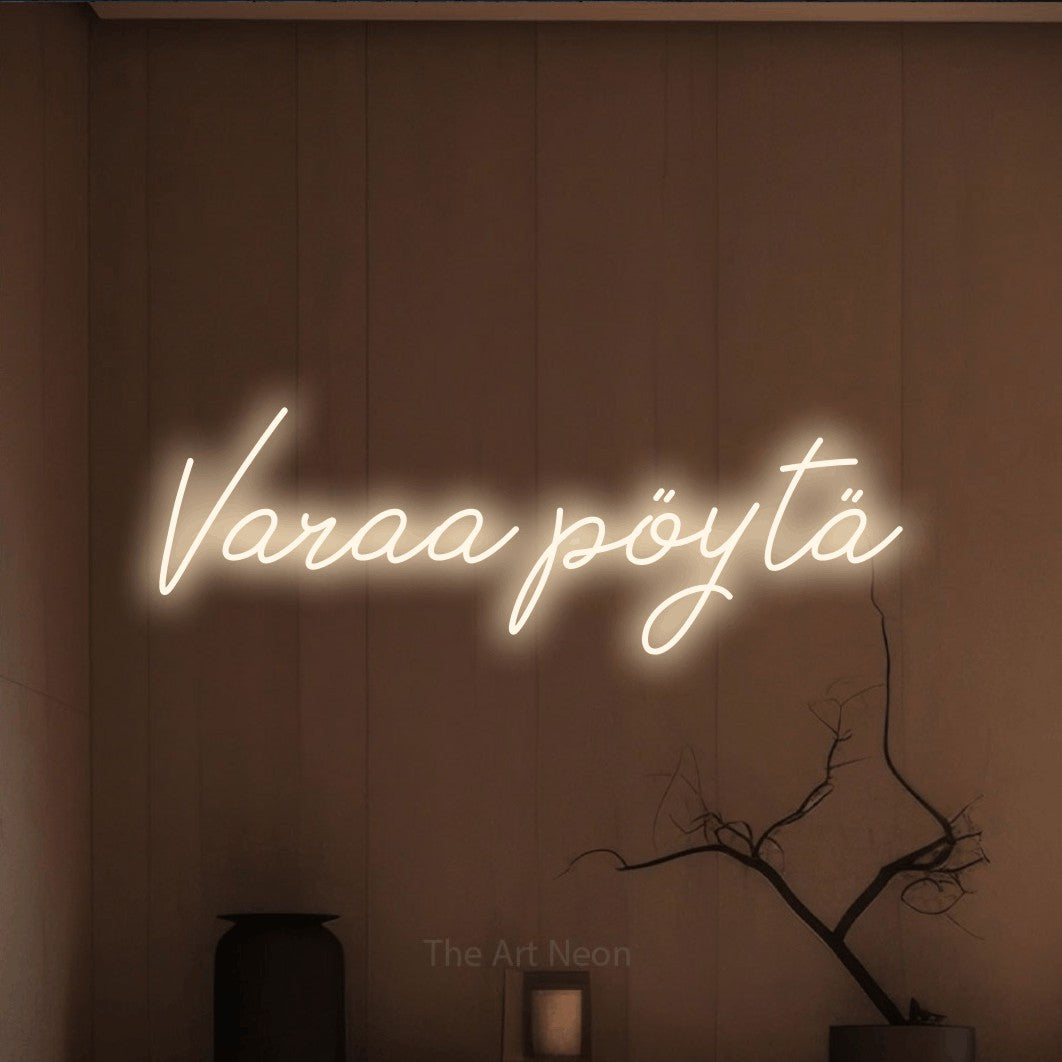 LED neon sign reading “Varaa pöytä”, arranged in a single line.