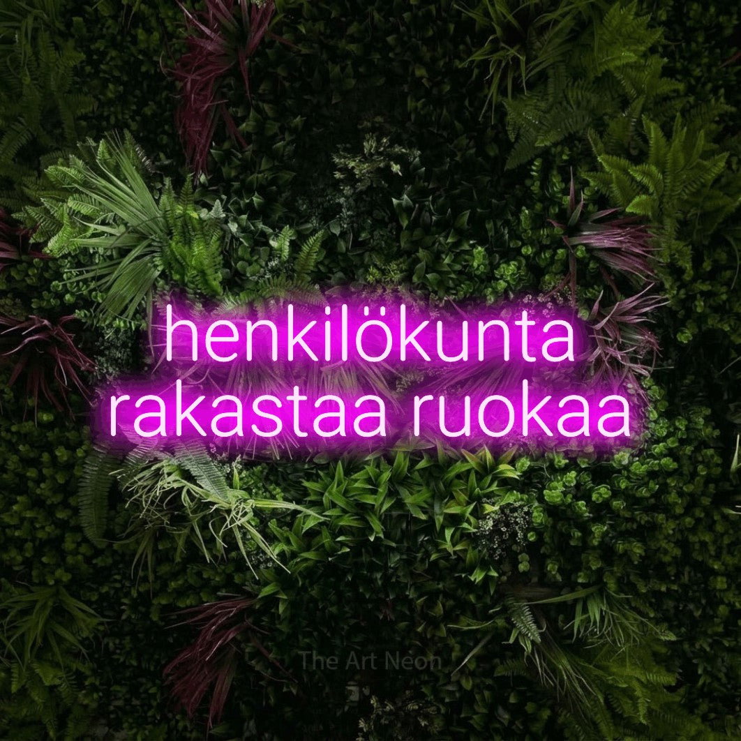 LED neon sign reading “henkilökunta rakastaa ruokaa”, arranged in 2 lines.