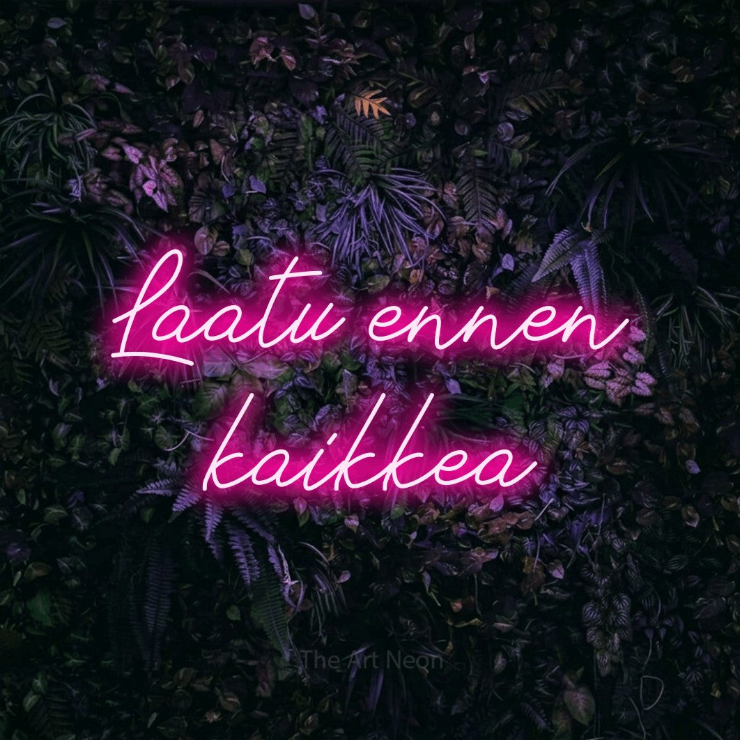 LED neon sign reading “Laatu ennen kaikkea”, arranged in 2 lines.