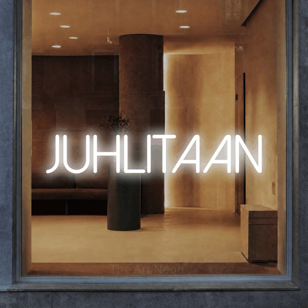 LED neon sign reading “juhlitaan”, arranged in a single line.