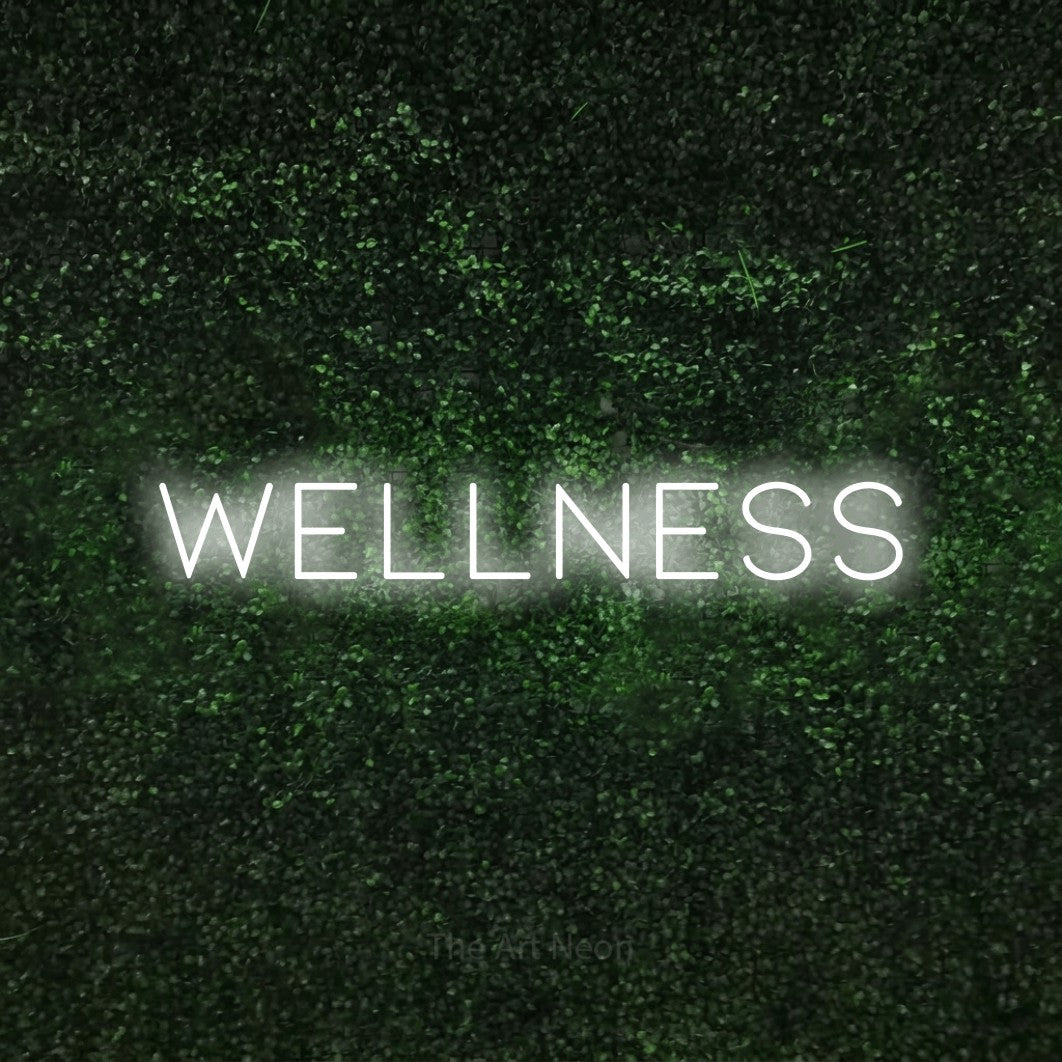 LED neon sign reading “WELLNESS”, arranged in a single line.
