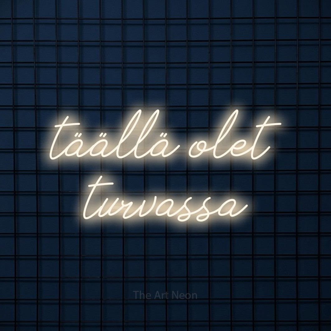LED neon sign reading “täällä olet turvassa”, arranged in 2 lines.