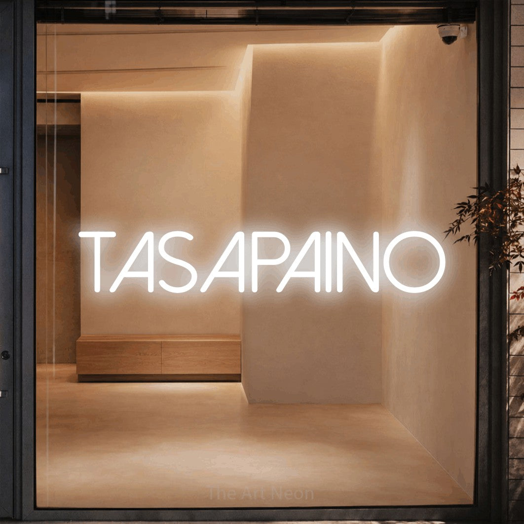 LED neon sign reading “TASAPAINO”, arranged in a single line.