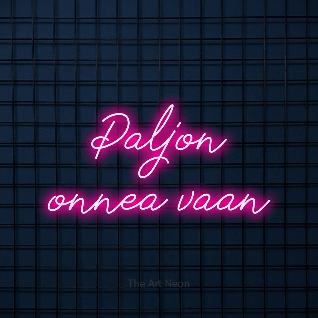 LED neon sign reading “Paljon onnea vaan”, arranged in 2 lines.