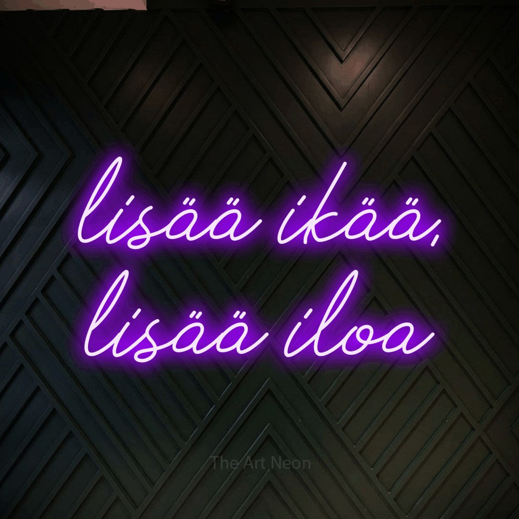 LED neon sign reading “lisää ikää, lisää iloa”, arranged in 2 lines.