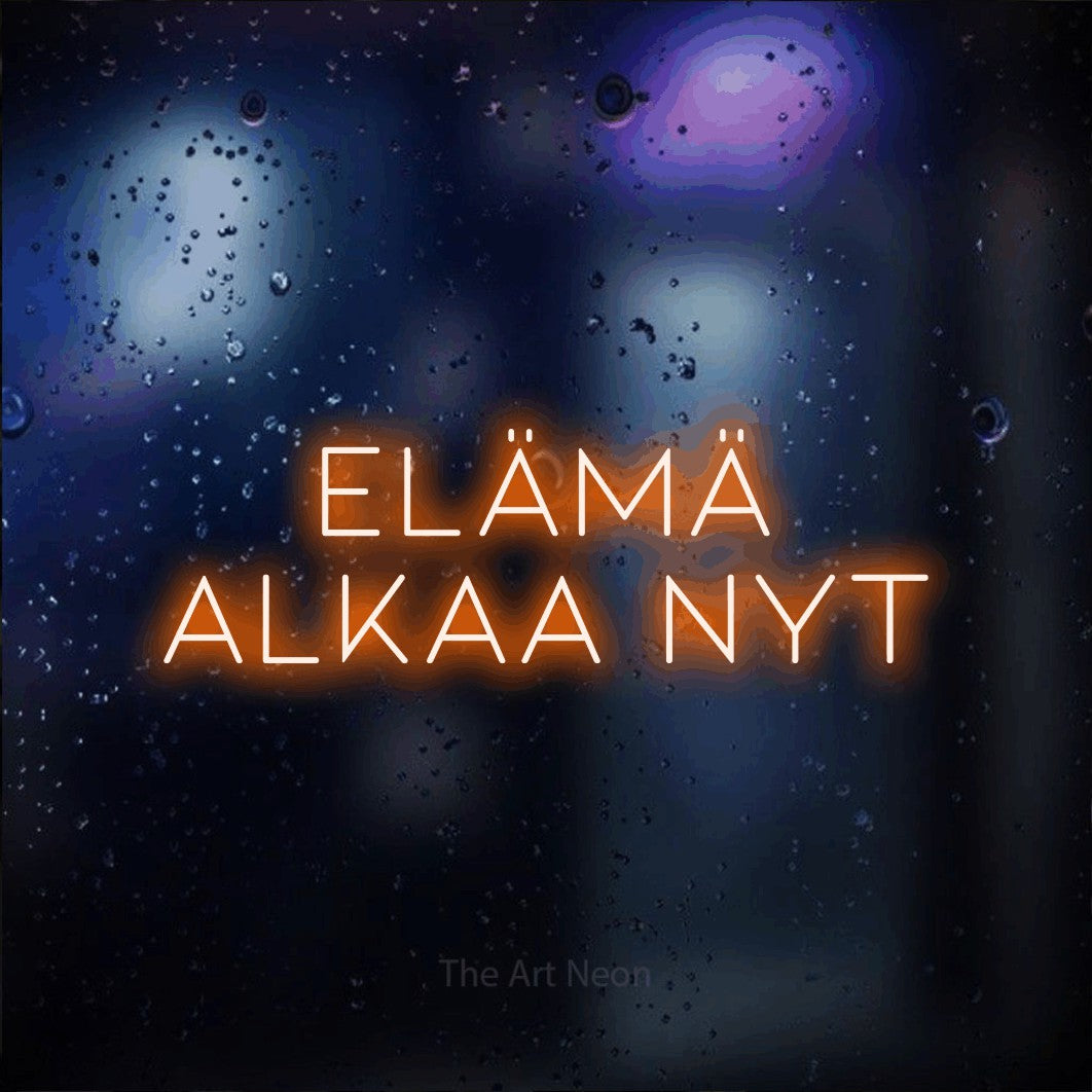 LED neon sign reading “ELÄMÄ alkaa nyt”, arranged in 2 lines.