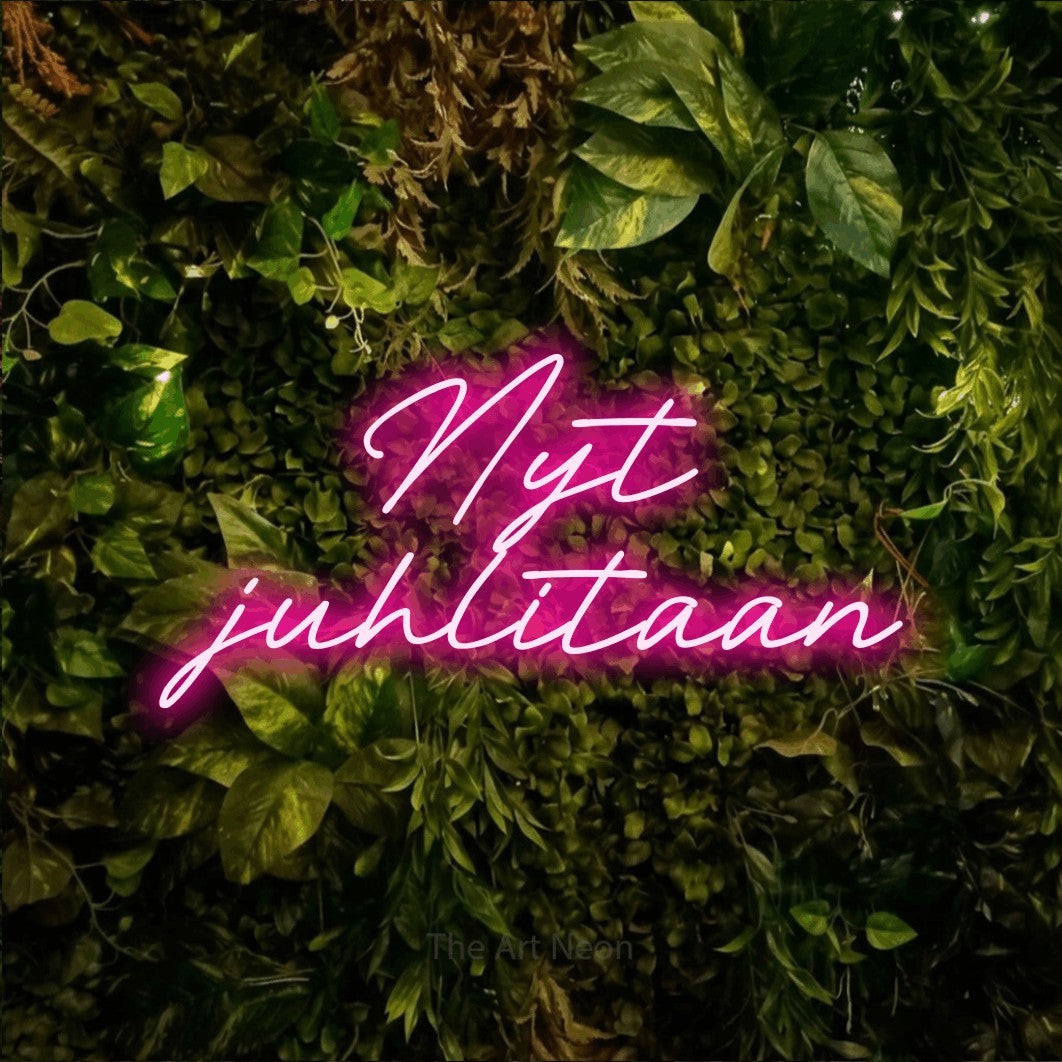 LED neon sign reading “Nyt juhlitaan”, arranged in 2 lines.