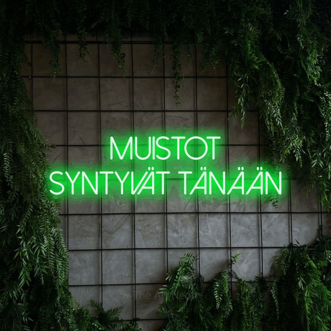 LED neon sign reading “MUISTOT SYNTYVÄT TÄNÄÄN”, arranged in 2 lines.