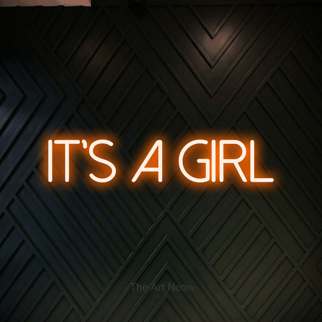 LED neon sign reading “It's a girl”, arranged in a single line.