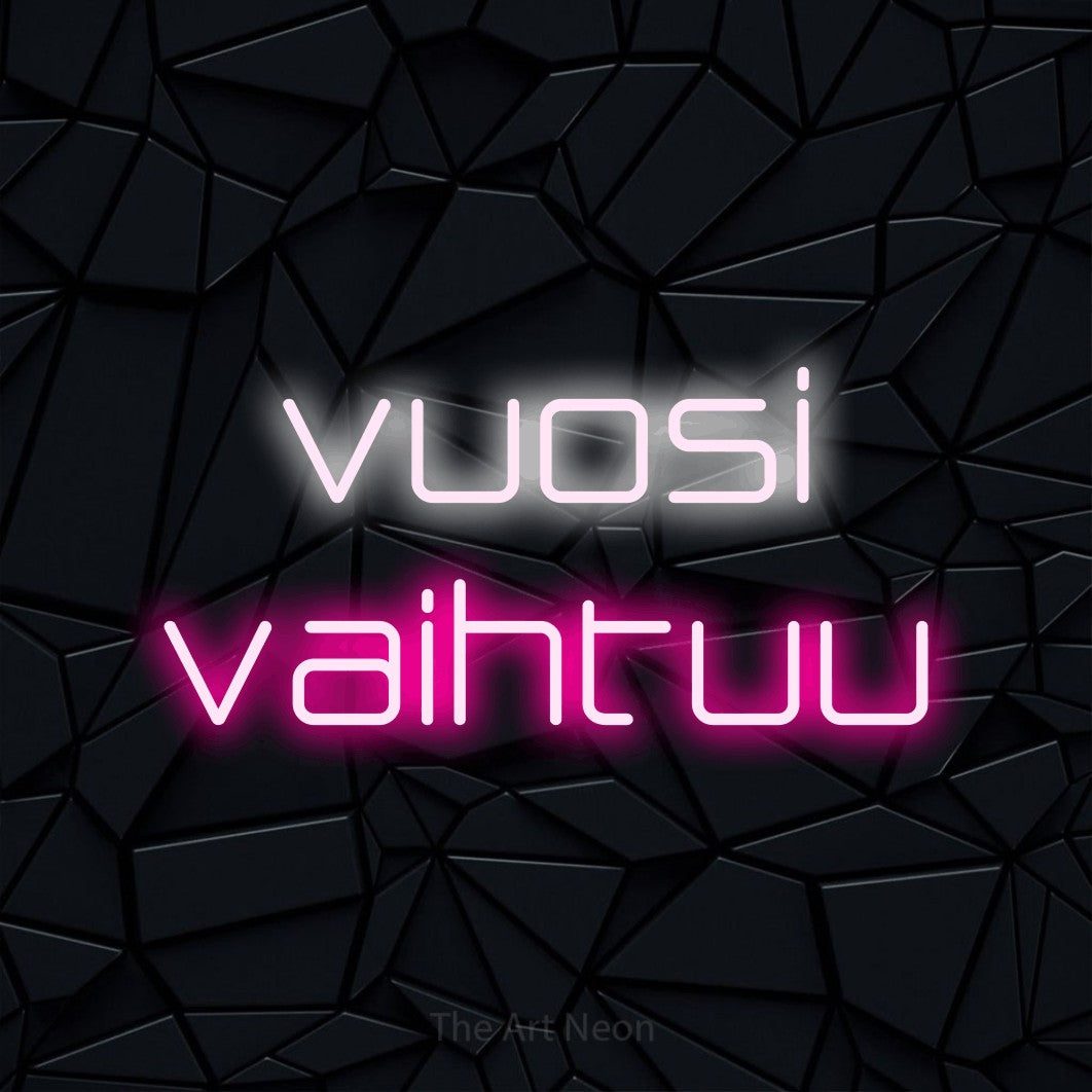 LED neon sign reading “vuosi vaihtuu”, arranged in 2 lines.
