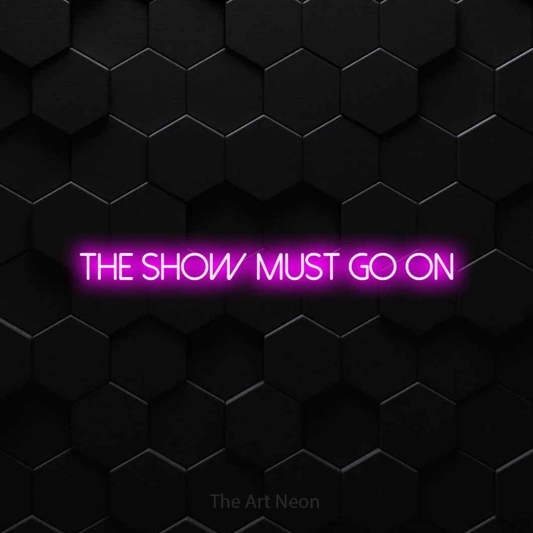 LED neon sign reading “the show must go on”, arranged in a single line.