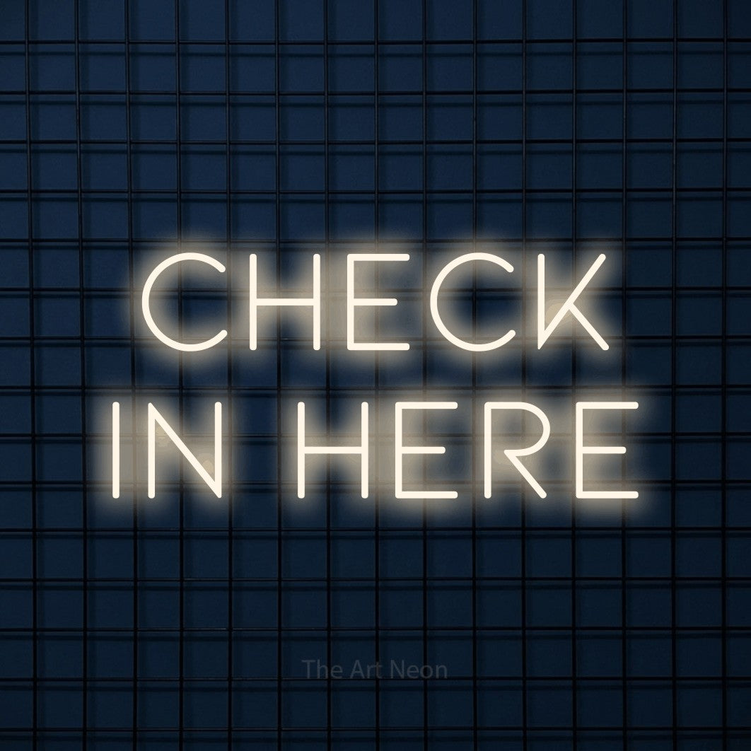 LED neon sign reading “Check in here”, arranged in 2 lines.