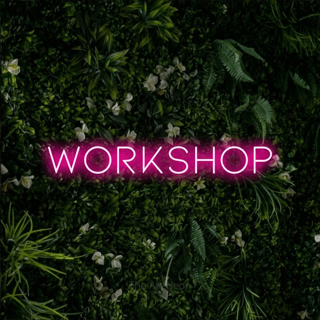 LED neon sign reading “WORKSHOP”, arranged in a single line.