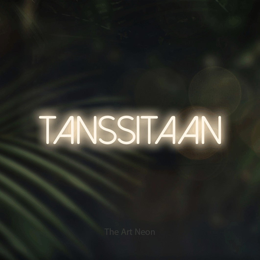 LED neon sign reading “TANSSITAAN”, arranged in a single line.