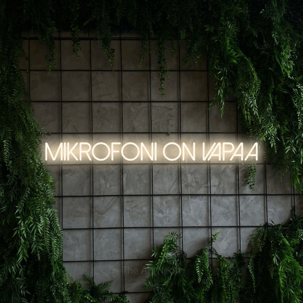 LED neon sign reading “Mikrofoni on vapaa”, arranged in a single line.