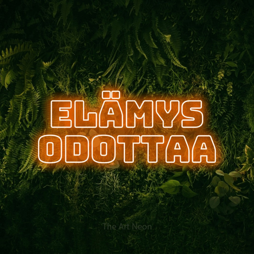 LED neon sign reading “ELÄMYS ODOTTAA”, arranged in 2 lines.