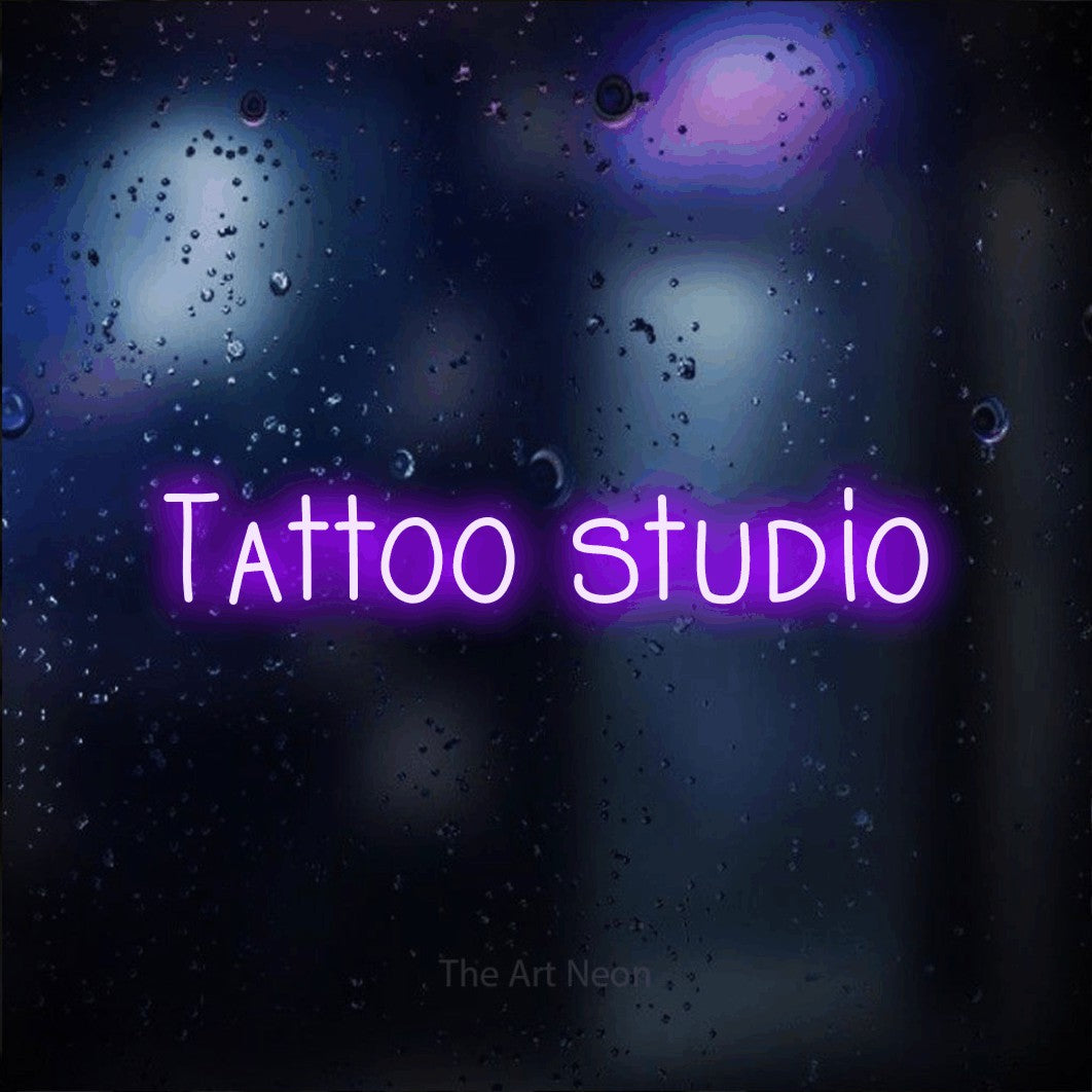 LED neon sign reading “Tattoo studio”, arranged in a single line.