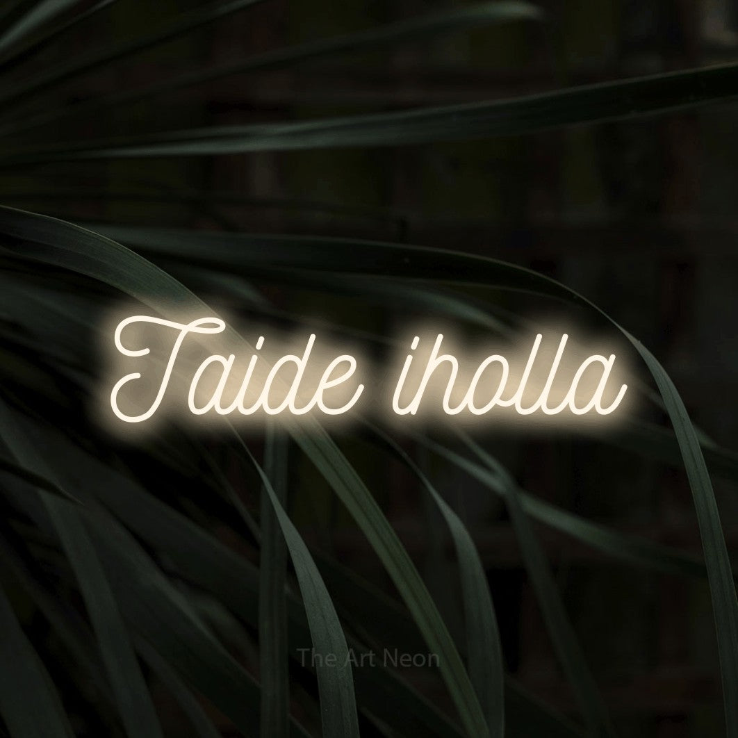 LED neon sign reading “Taide iholla”, arranged in a single line.