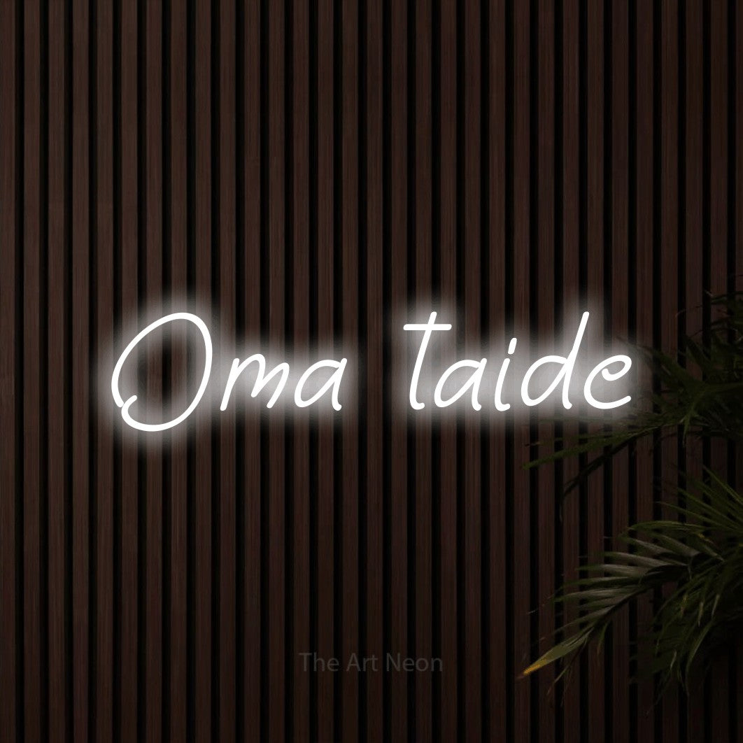 LED neon sign reading “Oma taide”, arranged in a single line.