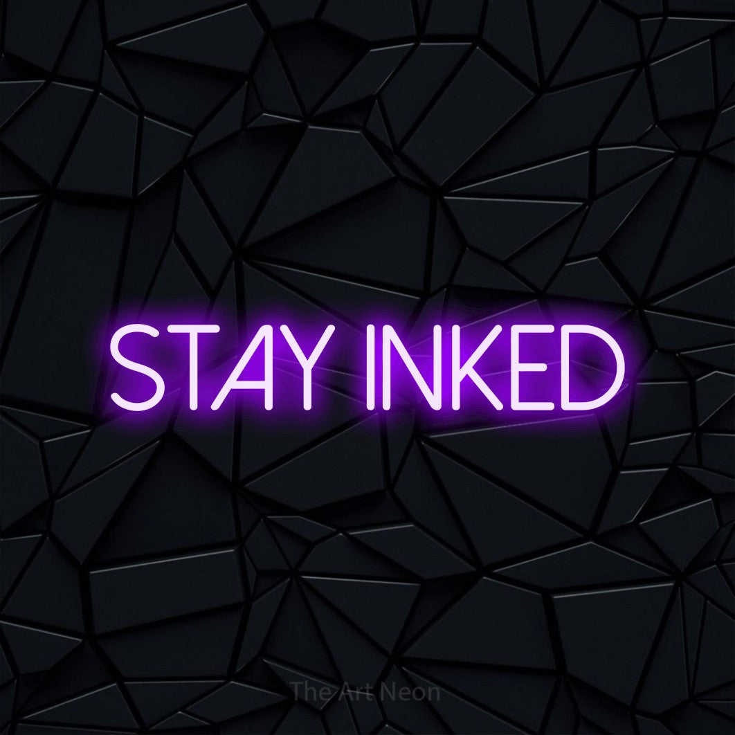 LED neon sign reading “Stay inked”, arranged in a single line.