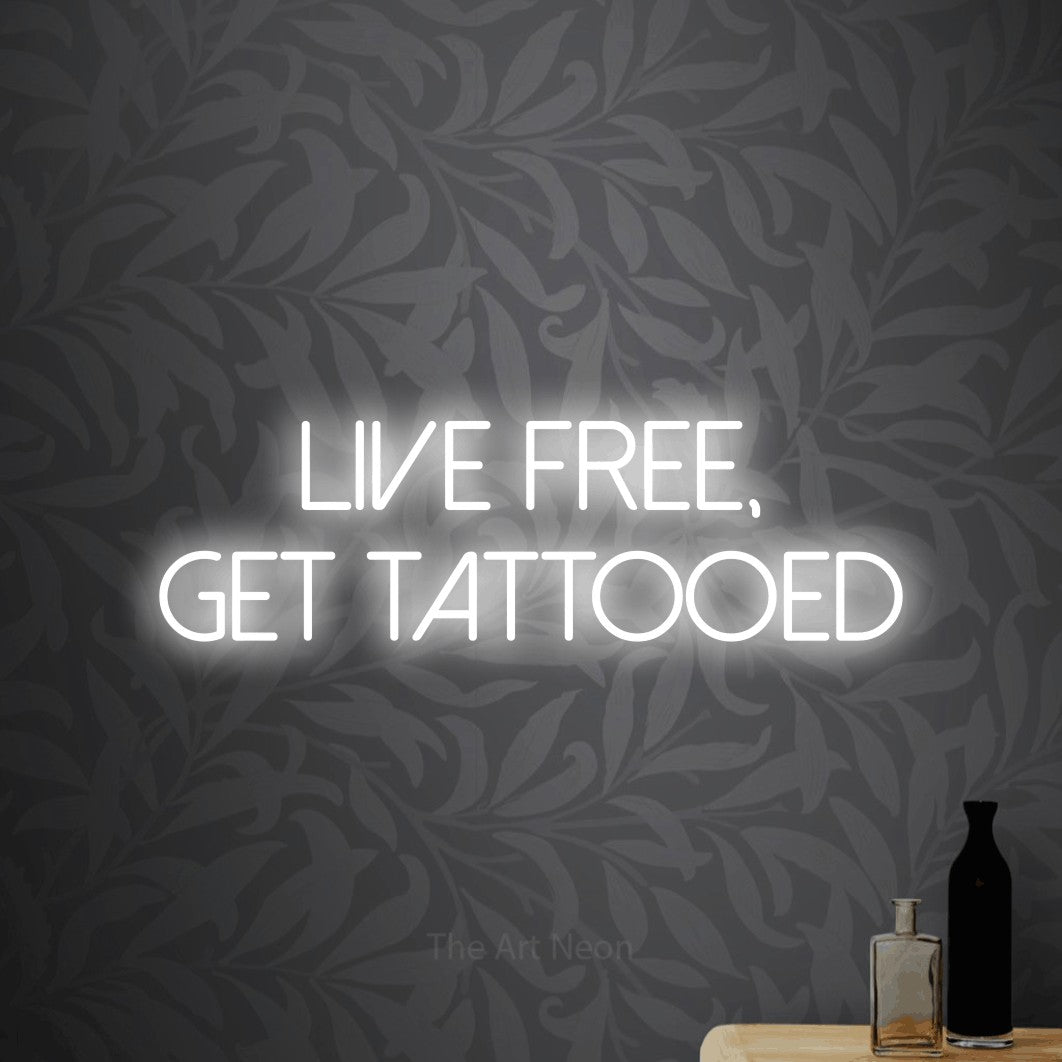 LED neon sign reading “Live free, get tattooed”, arranged in 2 lines.