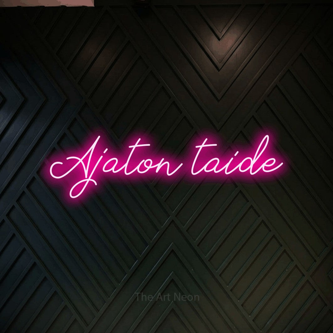 LED neon sign reading “Ajaton taide”, arranged in a single line.