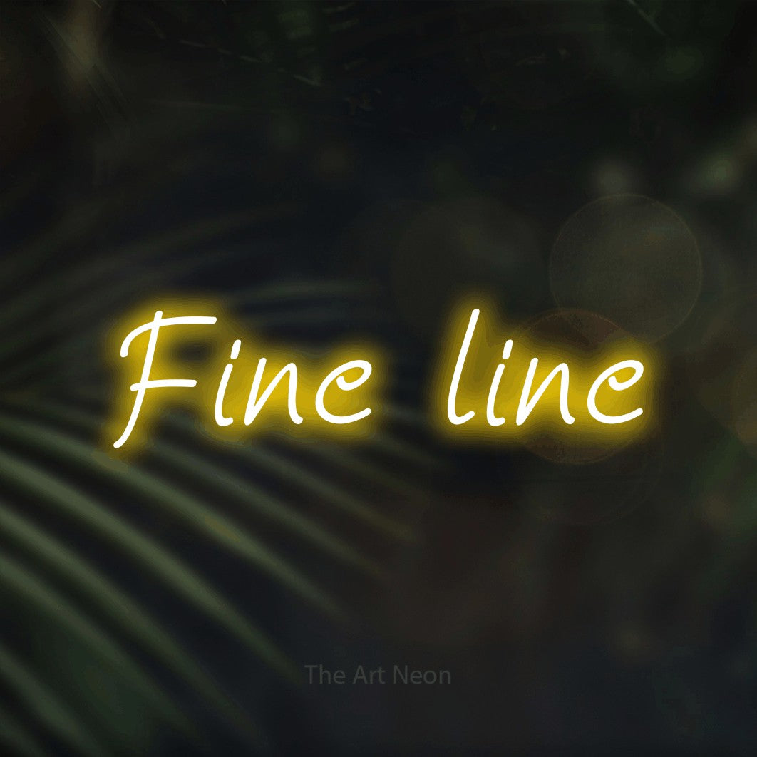 LED neon sign reading “Fine line”, arranged in a single line.